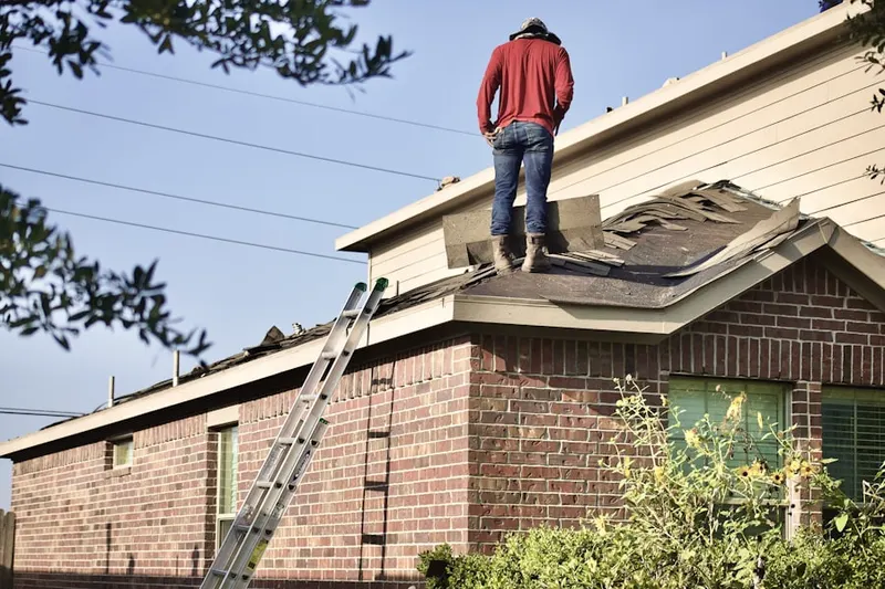 Professional roofer working on a residential roof in River Colony East